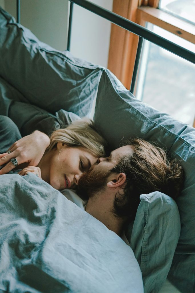 Couple connecting emotionally in bed representing secure attachment and emotionally focused therapy in Wodonga